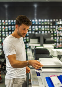 Man choosing printer in store